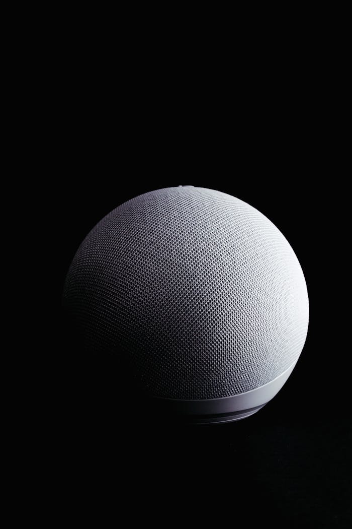 Close-up product shot of a spherical electronic device against a black background.