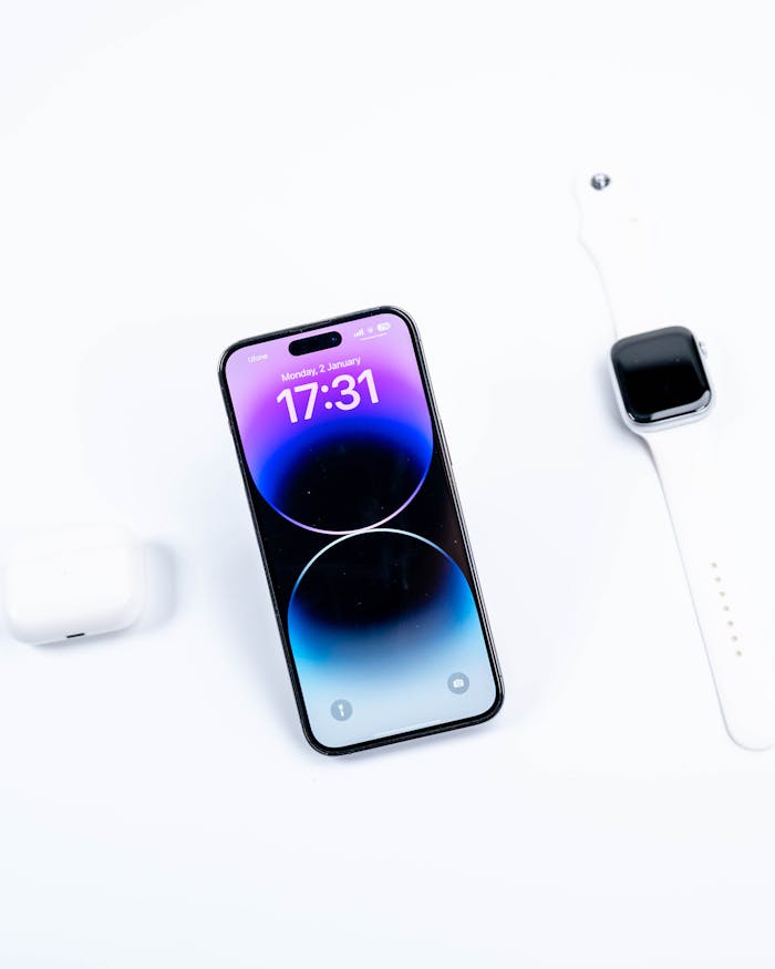 Exploring modern technology with a sleek smartphone and smartwatch in a minimalist layout.